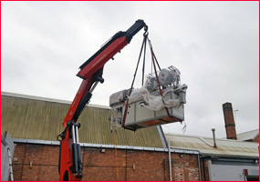 lifting new machine into factory